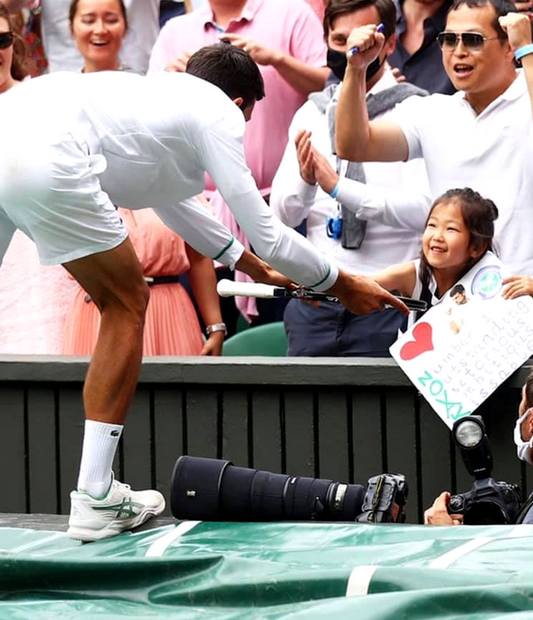 Novak Djokovic and a little girl fan